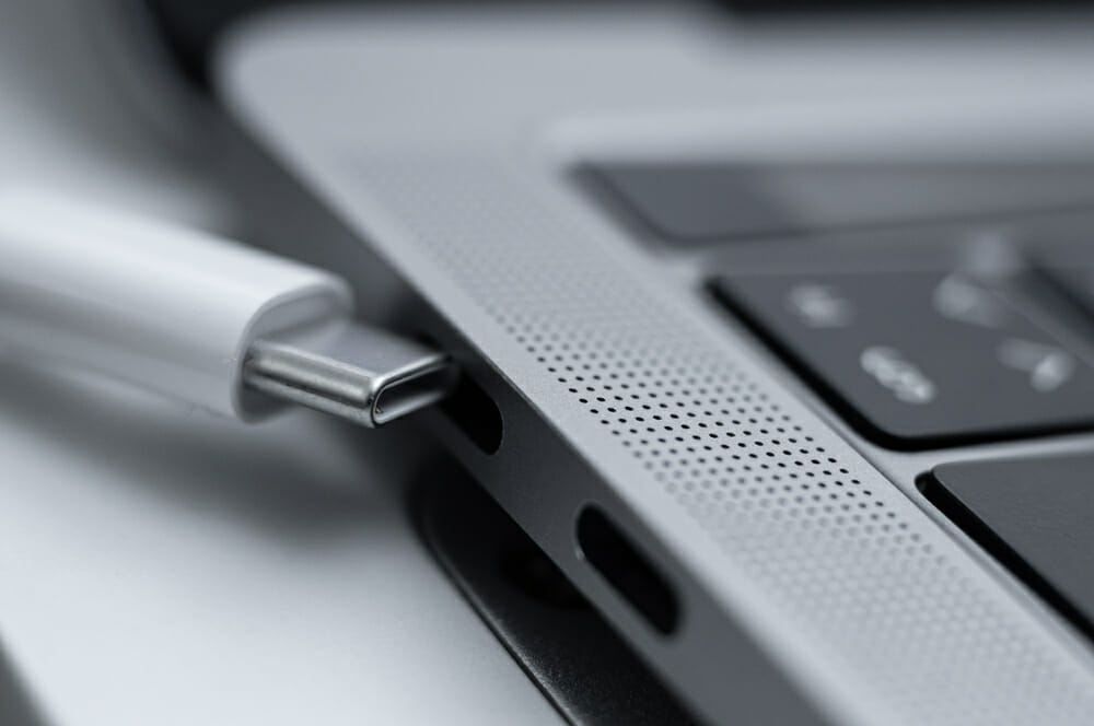 Grey thunderbolt cable and a laptop